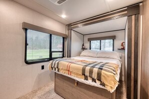 Wake up to peaceful views and soft morning light through dual bedroom windows.