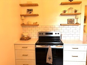 Brand new appliances, cabinets, and quartz countertops. Table in room seats four
