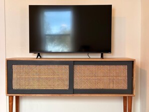 Smart TV, and board games in the TV console in the living area.