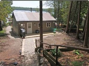 Leading down to cottage entrance. BBQ on deck deck