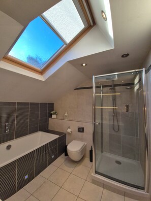 Bathroom with bathtub and shower. 