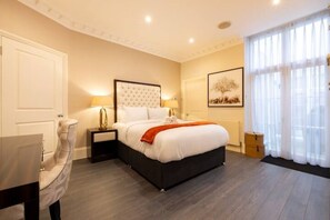 🛏️ Elegant bedroom with tufted headboard & natural light

