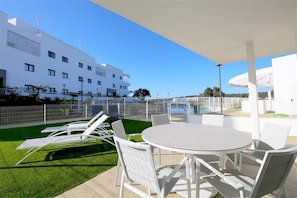 Large and sunny terrace with outdoor dining area for six guests and grass area