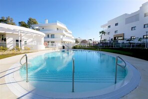 Inviting communal swimming pool located a few steps away from the property