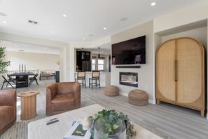 Large TV with electric fireplace in the main living area