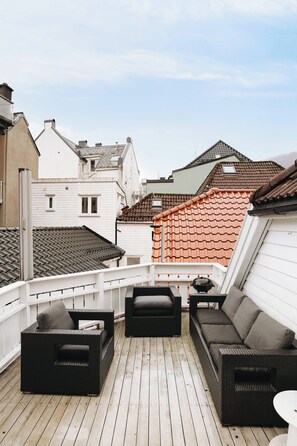 Relaxing patio setting overlooking the rooftops.