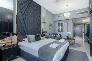King size bed with linen, blanket and towels.