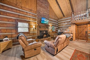 Stacked Stone Wood Burning Fireplace and Leather Reclining Seating