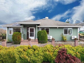 The house presents a harmonious blend of style and comfort, with its well-designed exterior and thoughtful features. Its inviting aesthetic is complemented by lush landscaping making it a welcoming and functional space for any stay.
