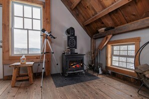 Cozy up by the wood-burning stove or gaze at the stars with the telescope—relaxation and adventure all in one space!
