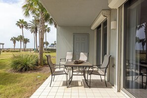 Ground Level Patio - Unit 101 features a ground level, Beach Front patio. Seating is provided and offers a great space for enjoying your morning coffee or evening cocktails.