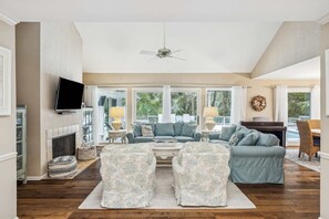 Bright living area with ample seating and TV