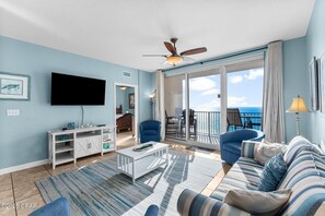 Open concept living area with balcony access and sleeper sofa