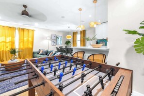 Chic living room with cozy seating and a foosball table for fun and relaxation