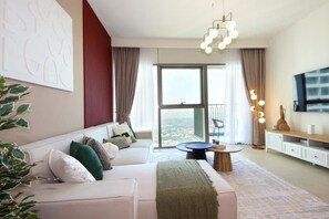 Living Room: Experience stunning skyline views while lounging on chic, plush furnishings!