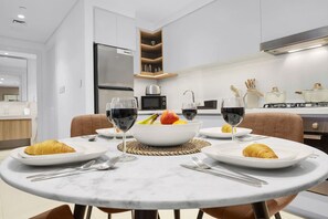 Dining Area: Elegant marble table awaits your culinary delights in this modern kitchen space!