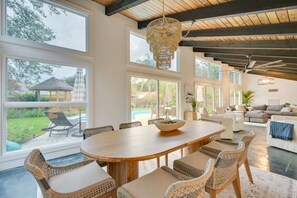 Gather around the spacious dining table, perfect for enjoying meals and making memories with family and friends.
