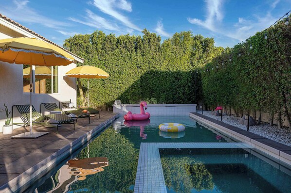 Pool and hot tub with sun loungers