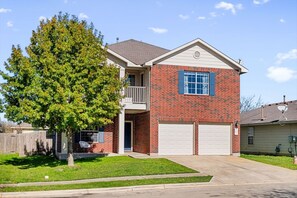 Charming 2-story brick home with a 2-car garage, covered porch, and balcony. Nestled in a quiet area near Dell Diamond and Kalahari Waterpark. Enjoy a private backyard and easy access to dining, parks —perfect for a relaxing Round Rock stay!