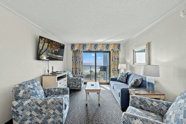 Relax in the comfort of a large well-appointed living room with an ocean view.