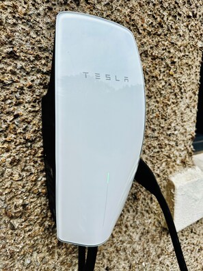 Tesla wall charger available for fast, convenient EV charging at Red Roofs
