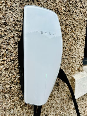 Tesla wall charger available for fast, convenient EV charging at Red Roofs
