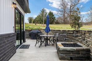 Outdoor seating, firepit, and grill. 