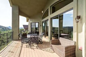 2nd Floor: 1st private balcony featuring an outdoor dining area with seating for 6 guests, outdoor seating, and a view of Prescott's natural scenery.