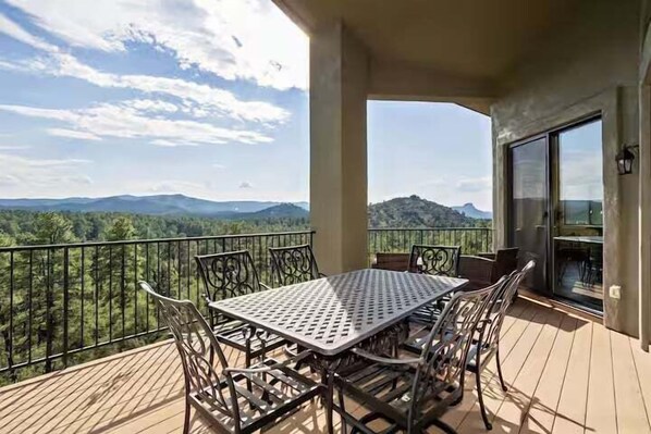 2nd Floor: 1st private balcony featuring an outdoor dining area with seating for 6 guests, outdoor seating, and a view of Prescott's natural scenery.