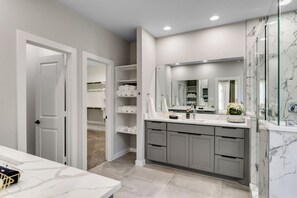 Walk in rain fall shower . His and hers vanity with plenty of closet storage