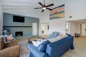 A stylish and comfortable living area featuring vaulted ceilings, a Smart TV, and a cozy fireplace—ideal for unwinding after a day of adventure








