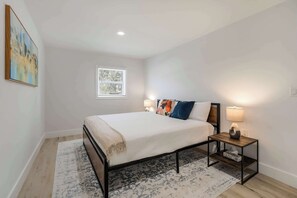 Unwind in this peaceful bedroom featuring a comfortable bed, stylish decor, and soft lighting for a restful night’s sleep.





