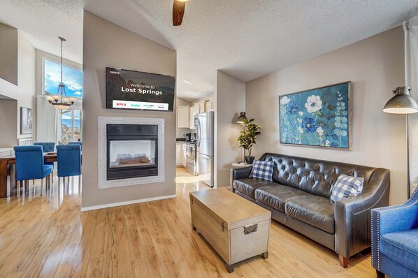 Welcome to Lost Springs! Relax in style with a cozy fireplace, plush seating, and an open-concept layout that flows seamlessly into the dining area..

