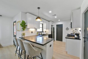Fully equipped kitchen with modern appliances, cookware, and utensils, ready for any culinary needs.