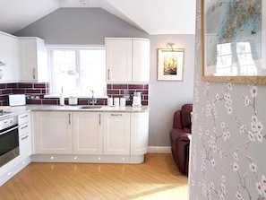 Interior Design, Furniture, Flooring, Countertop, Floor, Wood, Cabinetry, Kitchen, Ceiling, Light Fixture