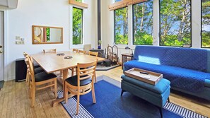 Family room has ten foot tall windows with Fox Island Marsh views