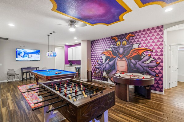 Game room with pool table, air hockey, foosball, and wet bar