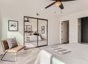 Primary bedroom. King size bed, closet mirrors, ceiling fan and amazing view