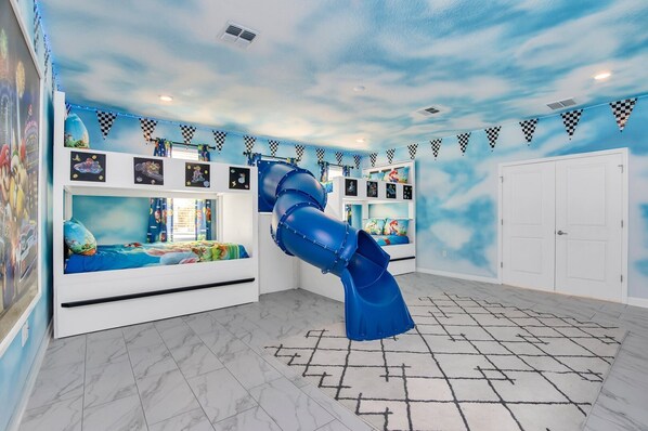 Sky-Themed Kids' Room with Slide and Bunk Beds