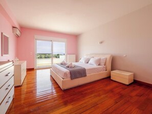 The master bedroom, offering a large double bed and a charming view