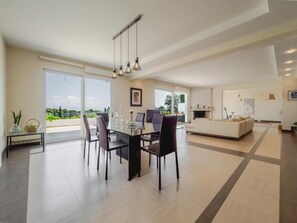 An open plan living room with a dinning area and kitchen
