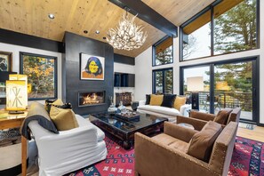 Gather round the woodburning fireplace, under the antler chandeliers.