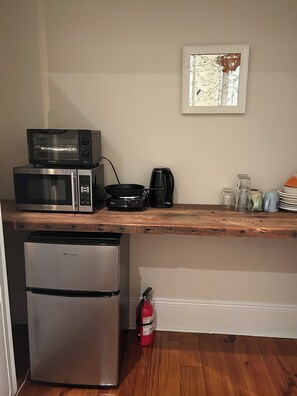 Front bedroom mini-kitchen with toaster oven, fridge, microwave, and hot plate