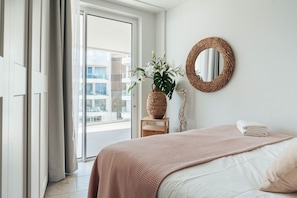 Enjoy a cozy retreat in this beautifully styled bedroom, featuring elegant decor and refreshing views.