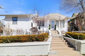 A beautifully preserved 1908 Craftsman home with classic woodwork, a charming front porch, and a warm, inviting atmosphere near historic Gurley Street.
