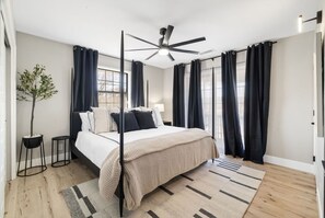 The king master suite combines 1908 charm with modern comforts, featuring an ensuite bath, stunning views, and a large smart TV.