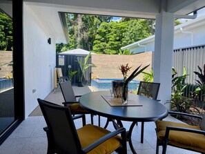 Outdoor dining area / Patio with spa in the background 