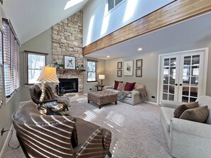 With soaring ceilings and a seasonal gas fireplace, this is a comfortable space to relax