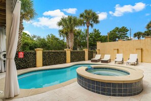 Beautiful pool in backyard with hot tub and sun shade