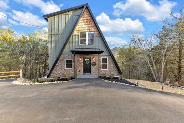 Enjoy this luxurious A-Frame featuring flat paved parking for multiple vehicles.